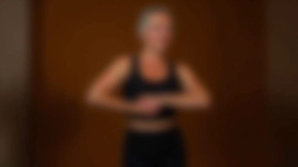 Dance instructor demonstrating proper posture and frame techniques to older students in studio
